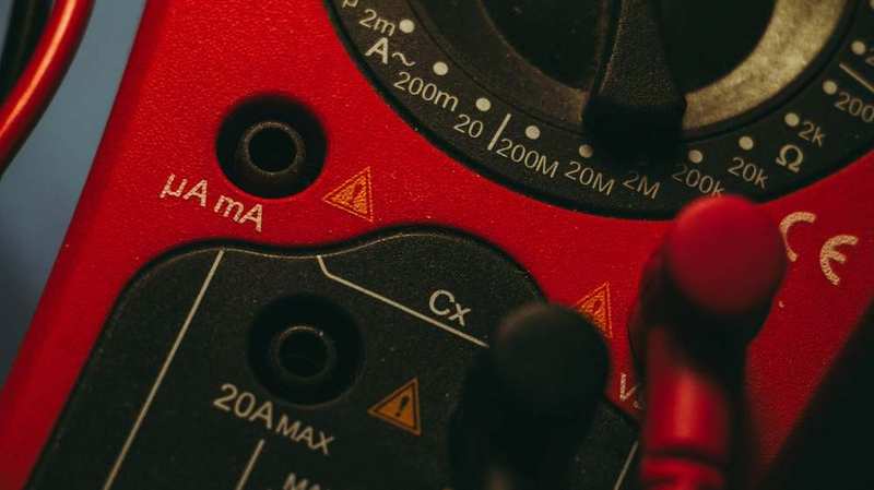 Electrician testing a circuit with a multimeter